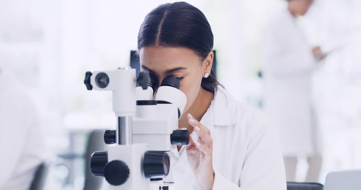 Scientist looking through microscope
